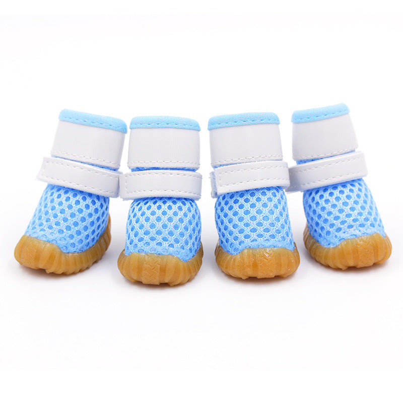 blue mesh dog boots with white straps and white background