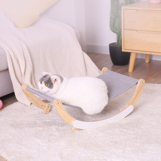 white cat laying in hammock rocking chair in bedroom