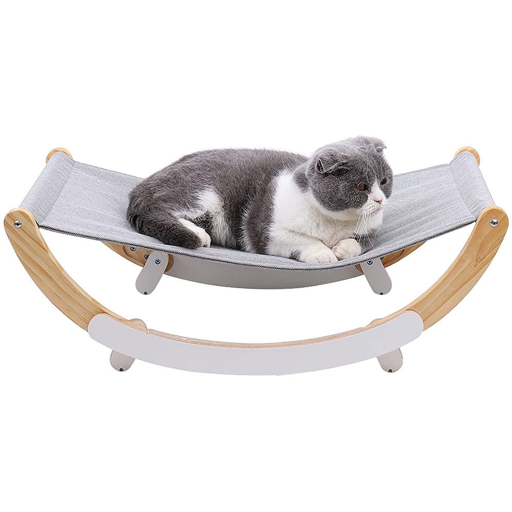 black and white cat laying on rocking hammock pet bed