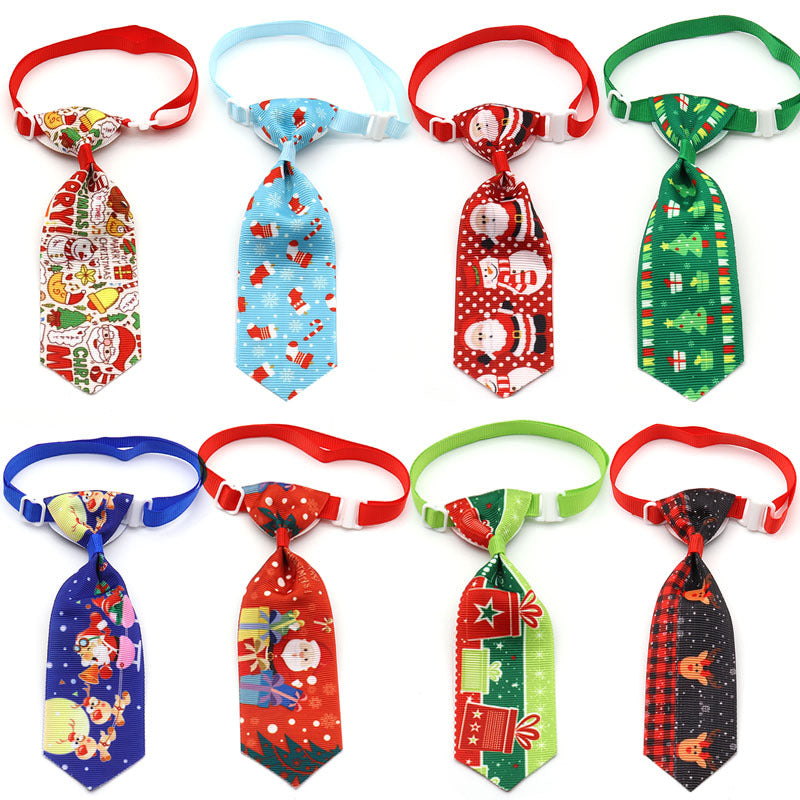 eight christmas pet ties laid out on white background