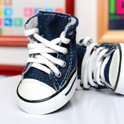 blue denim dog sneakers white lace sitting on table