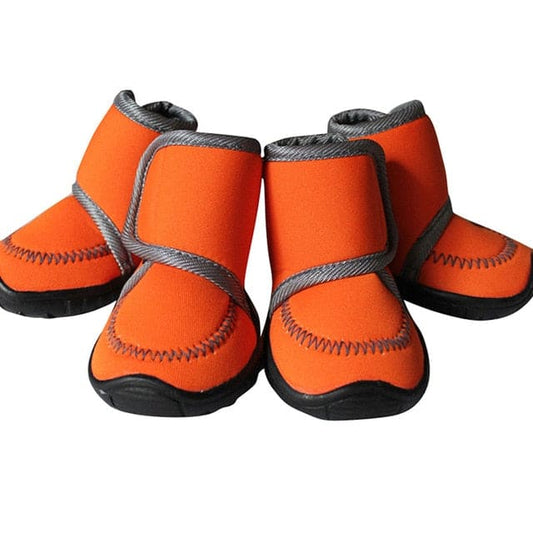 orange smooth material winter dog boots white background