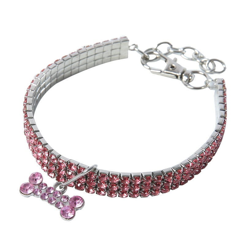 pink crystal dog collar with bone charm white background