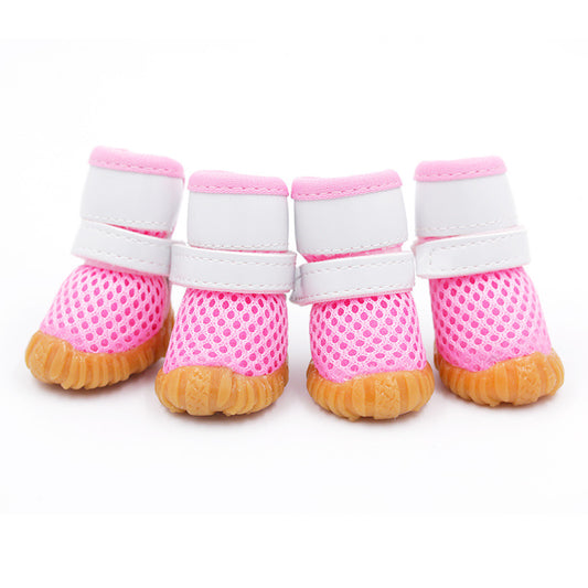 pink mesh dog shoes with white strap and white background