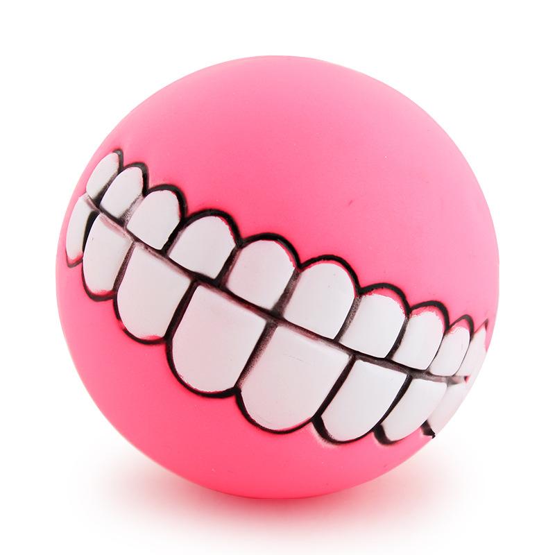 pink ball mouthed dog toy white background