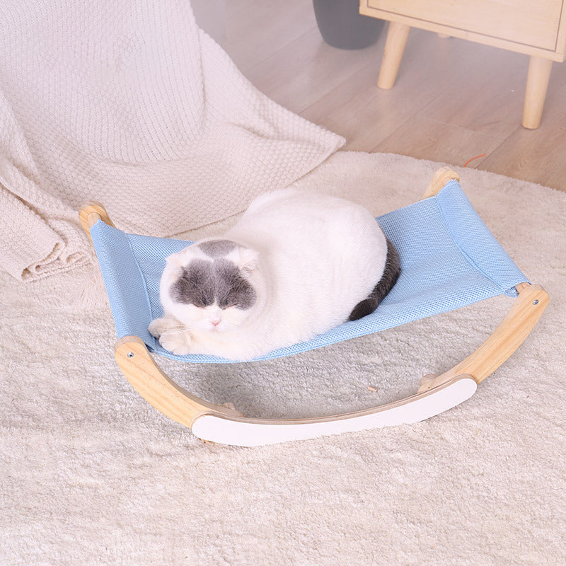 white laying on rocking hammock pet bed bedroom